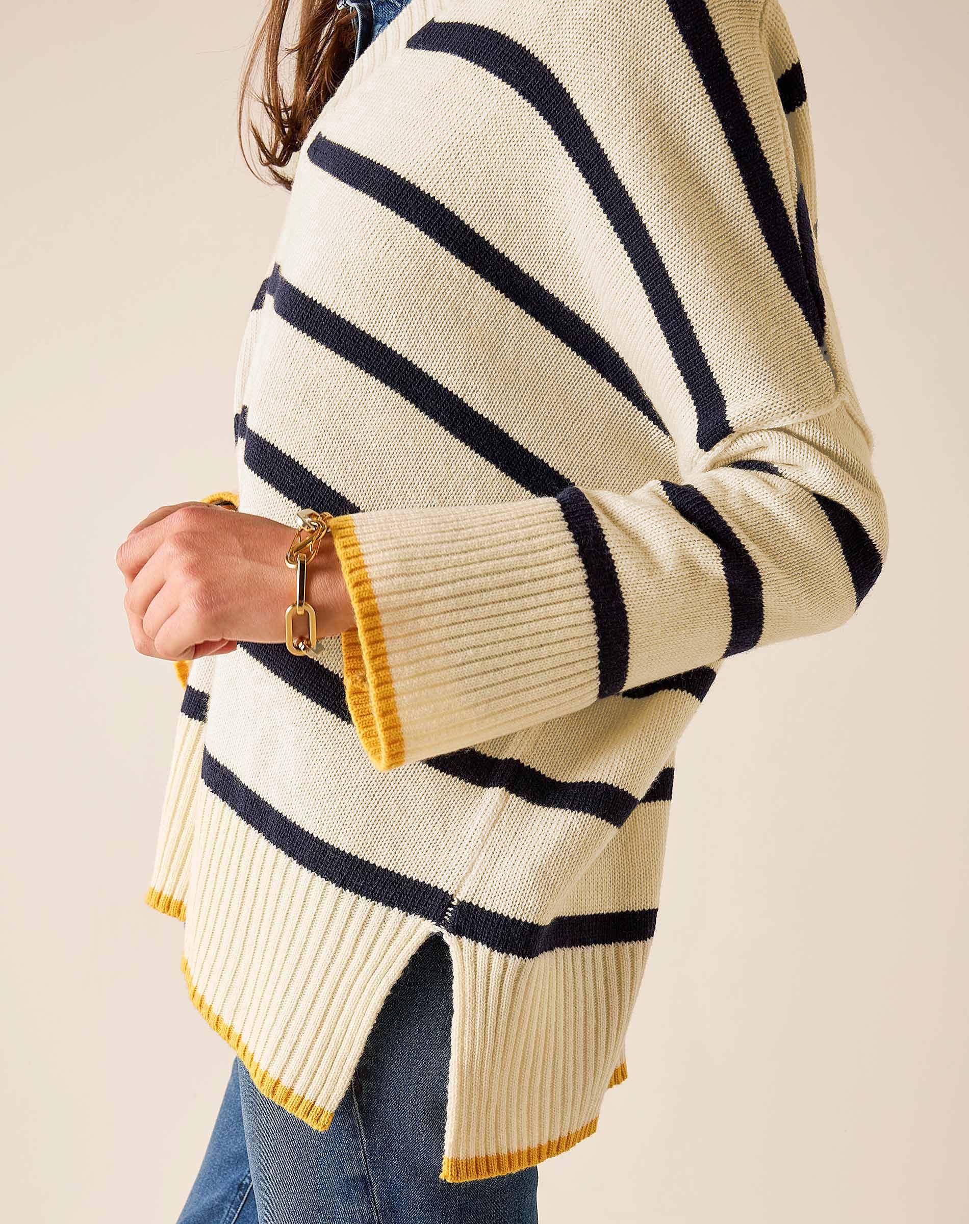 Cream knit sweater with navy and yellow stripes and a v-neck