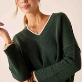 MERSEA ladies' travel-ready forest green V-neck knit sweater with cream trim and textured ribbed finish.