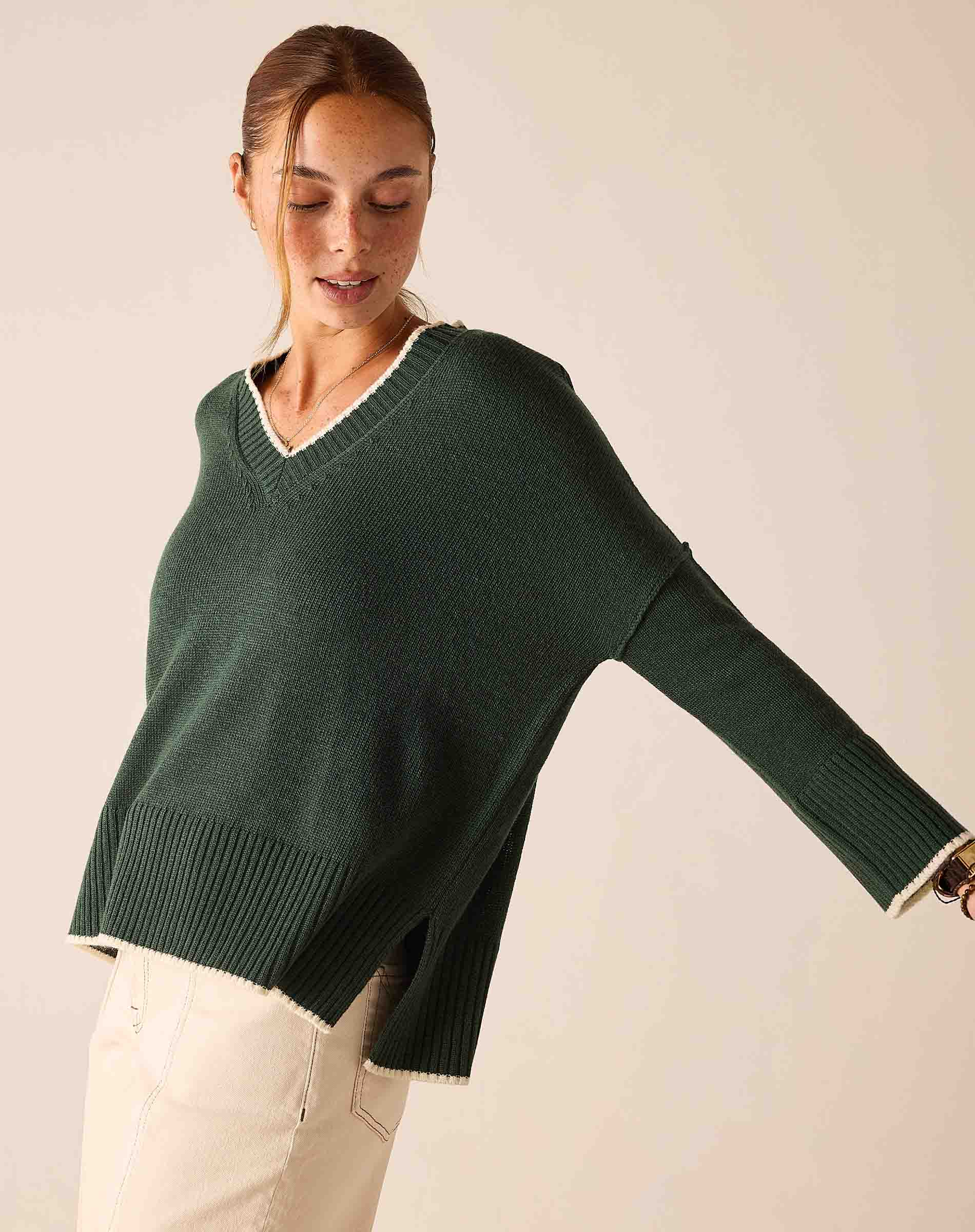 Forest green v-neck knit sweater with a relaxed fit and wide ribbed cuffs.