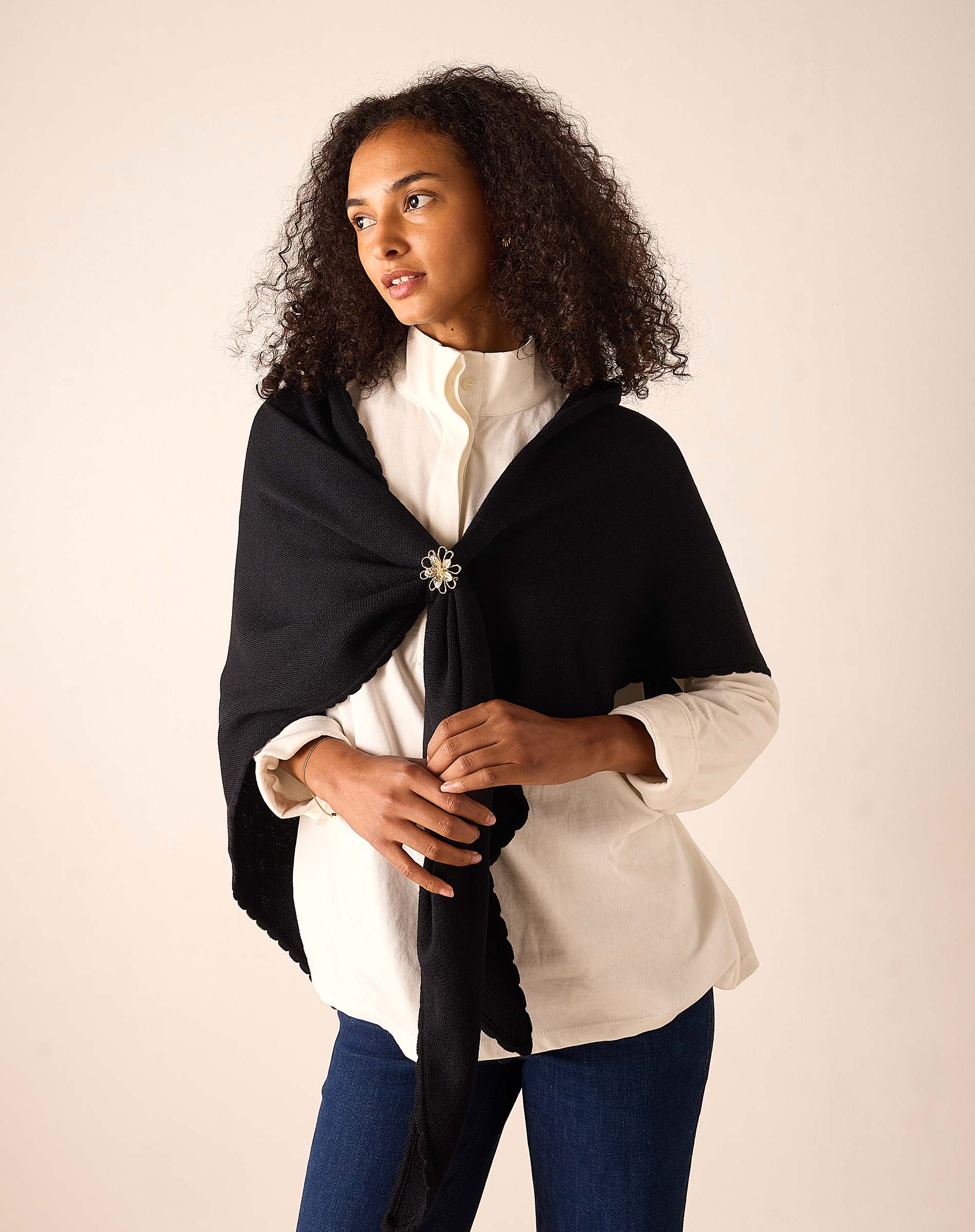 Women's travel-friendly black oversized wool-blend travel scarf with a decorative jeweled brooch detail.
