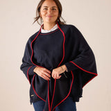 Ladies' travel-ready navy blue knit scarf with red trim.