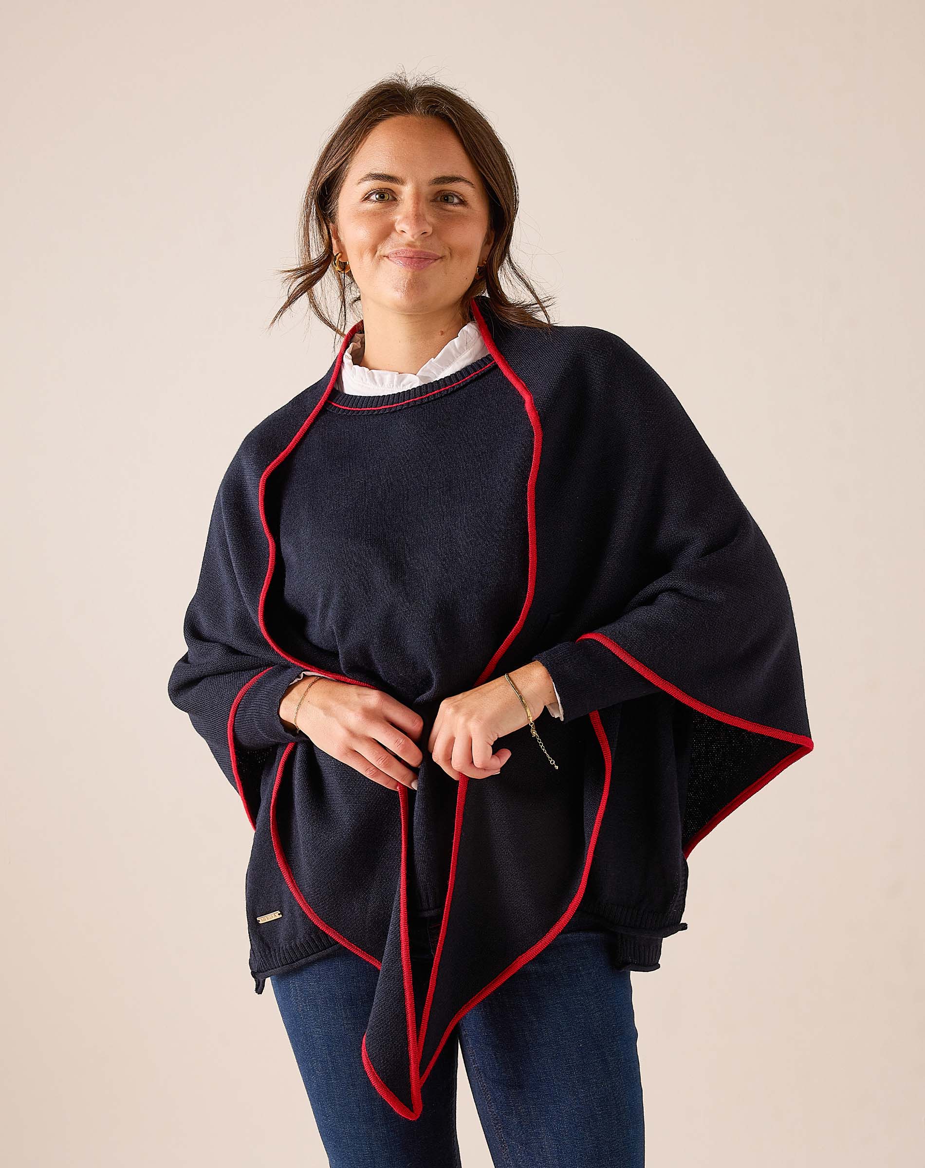 Ladies' travel-ready navy blue knit scarf with red trim.