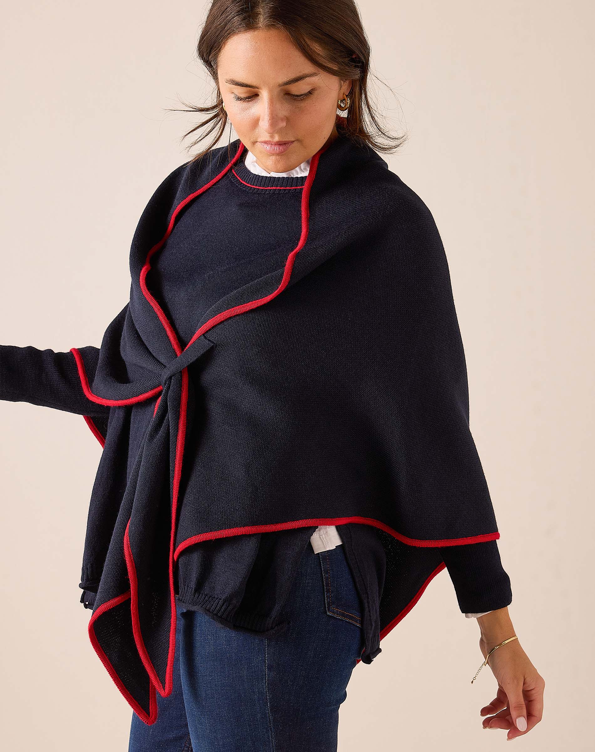 Navy blue wrap scarf with a red trim detail.