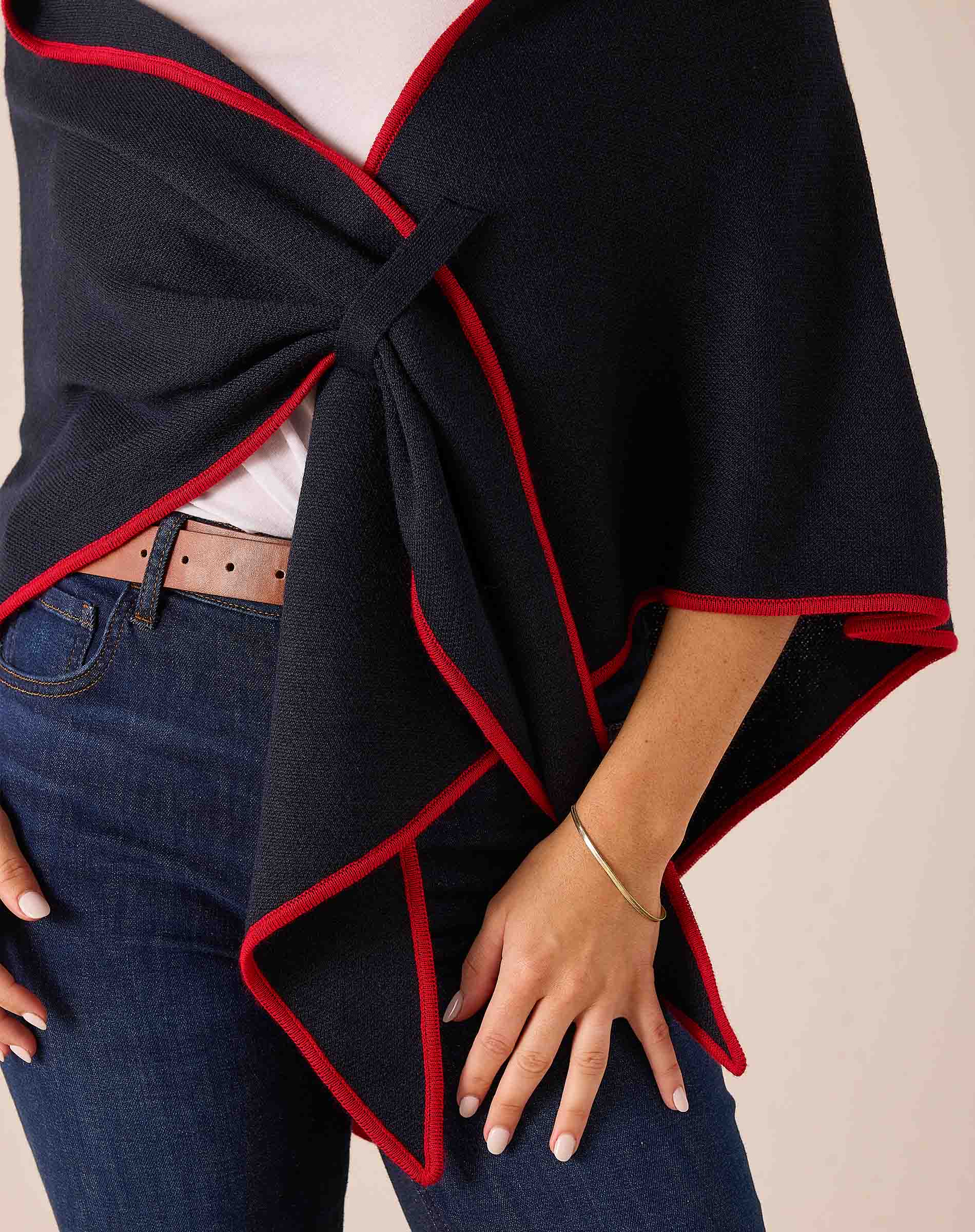 Navy and red draped wrap scarf with a front knot in a knit fabric.