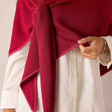 Wine pinkberry oversized knit scarf draped over a white linen shirt.