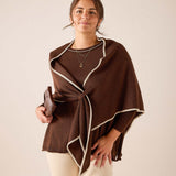 Coffee brown oversized knit wrap with cream trim and knot detail.