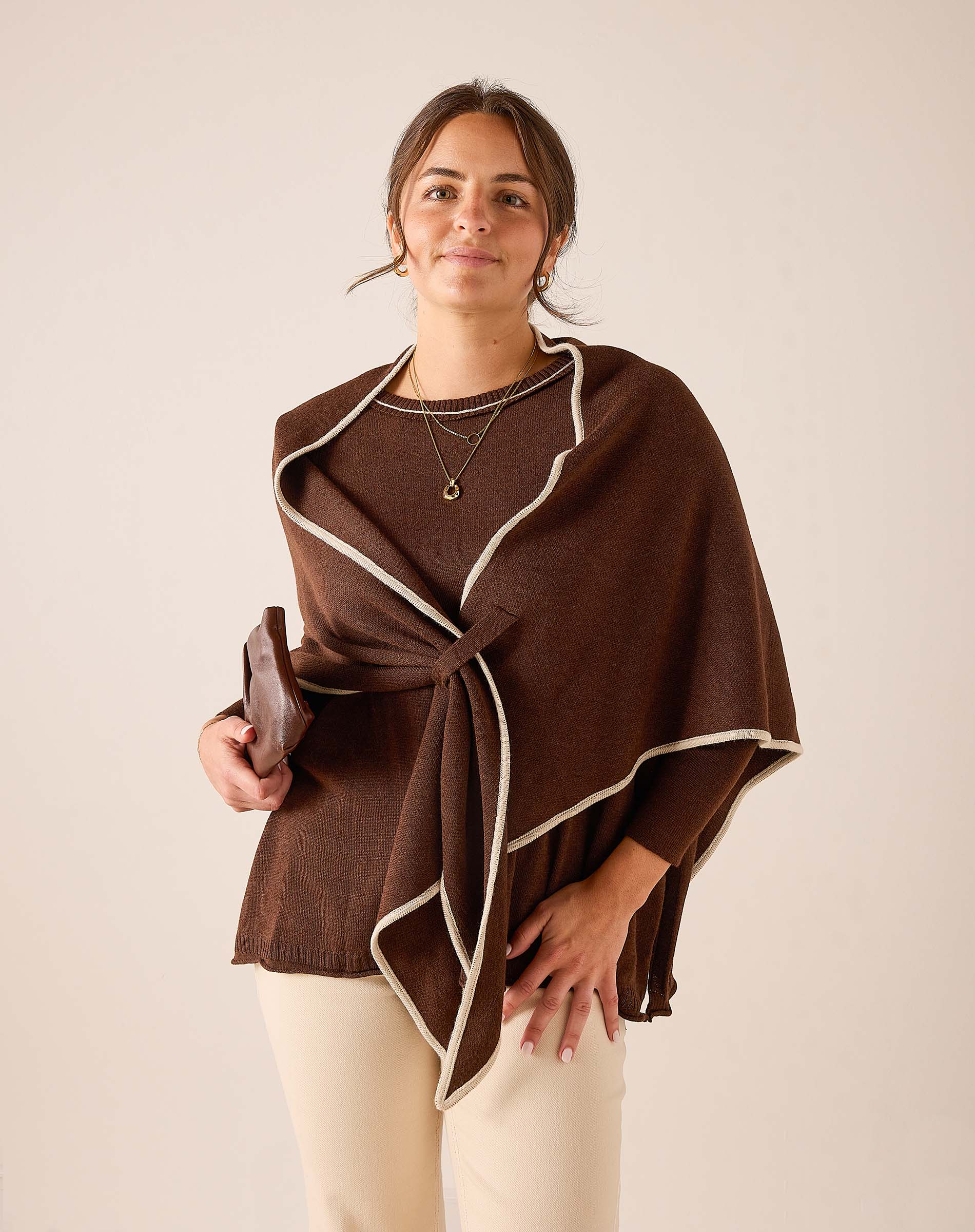 Coffee brown oversized knit wrap with cream trim and knot detail.
