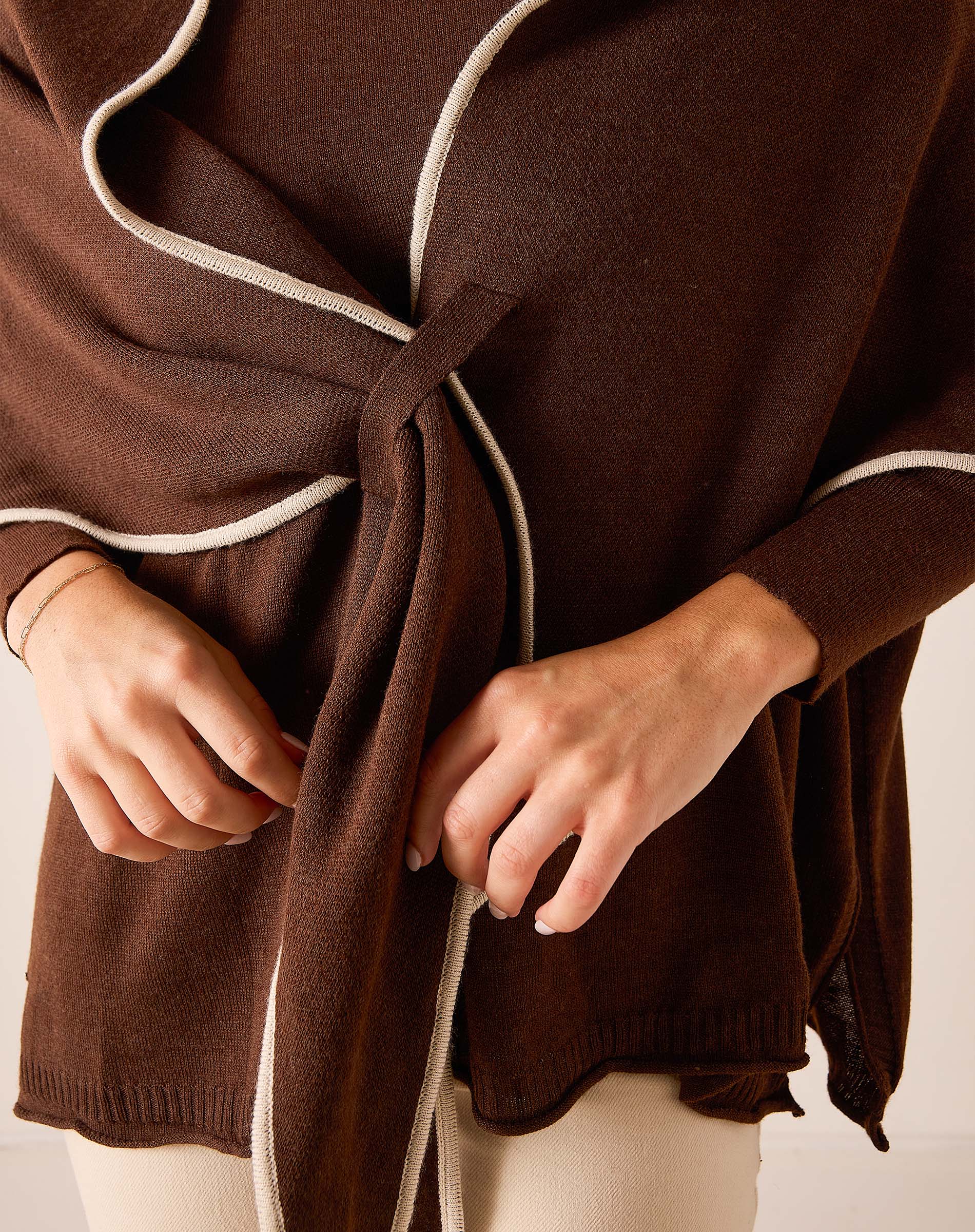 Coffee and cream color knit scarf with a front knot detail.