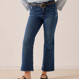 Medium-wash blue denim flare jeans with frayed hems and a vintage-inspired distressed look.