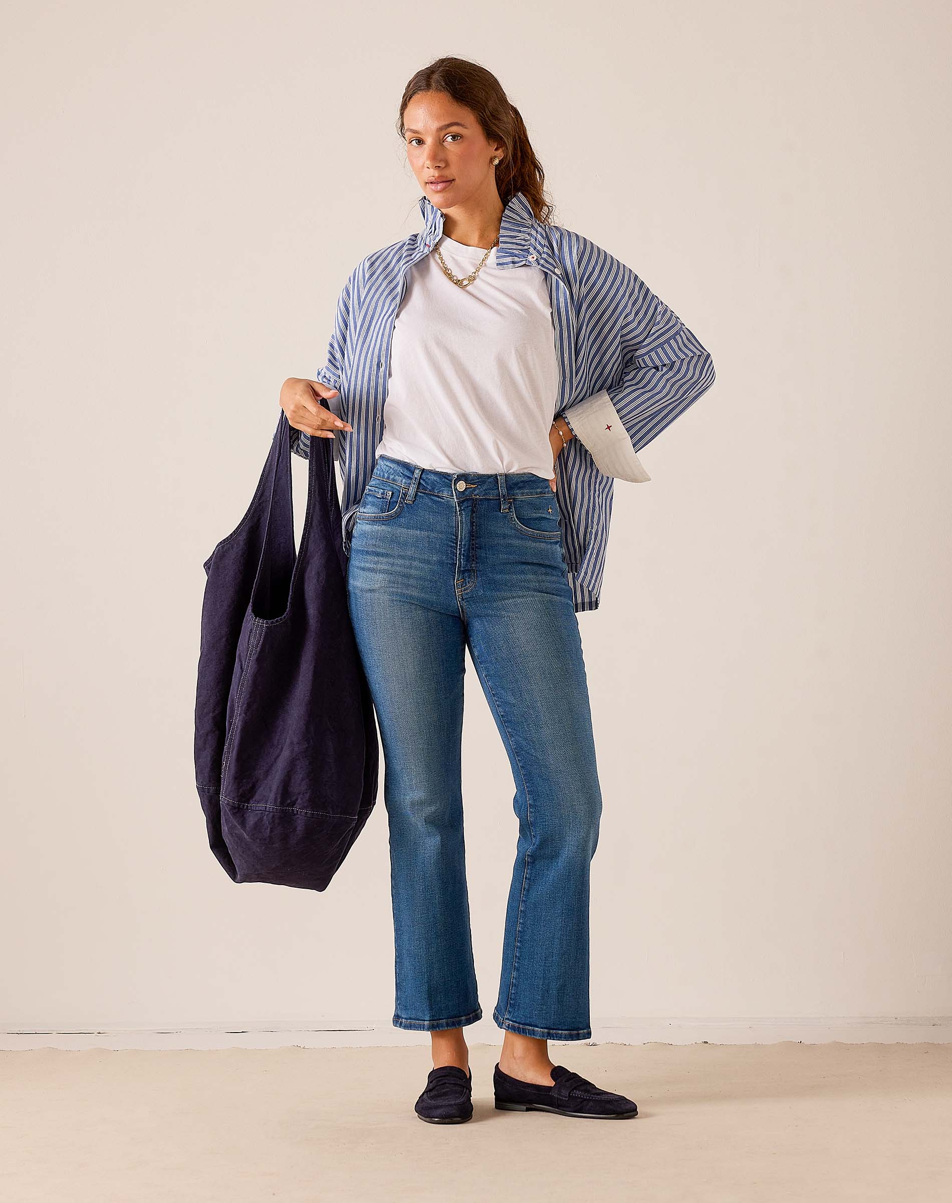 MERSEA women's travel-friendly navy blue oversized tote bag with top handles and wide shoulder straps.