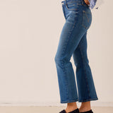 Medium blue flared denim jeans with frayed hems.