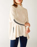 closeup of sleeve on woman wearing mersea newport sweater in salt storm white with grey accent stripe down lower sleeve with a split front turtleneck and ribbed sleeves
