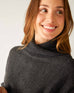 closeup of collar on woman wearing mersea newport sweater in storm grey with light salt accent stripe down lower sleeve with a split front turtleneck and ribbed sleeves