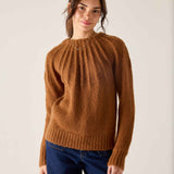 Ladies' travel-ready cinder orange knit sweater featuring a ribbed texture and pleated design.