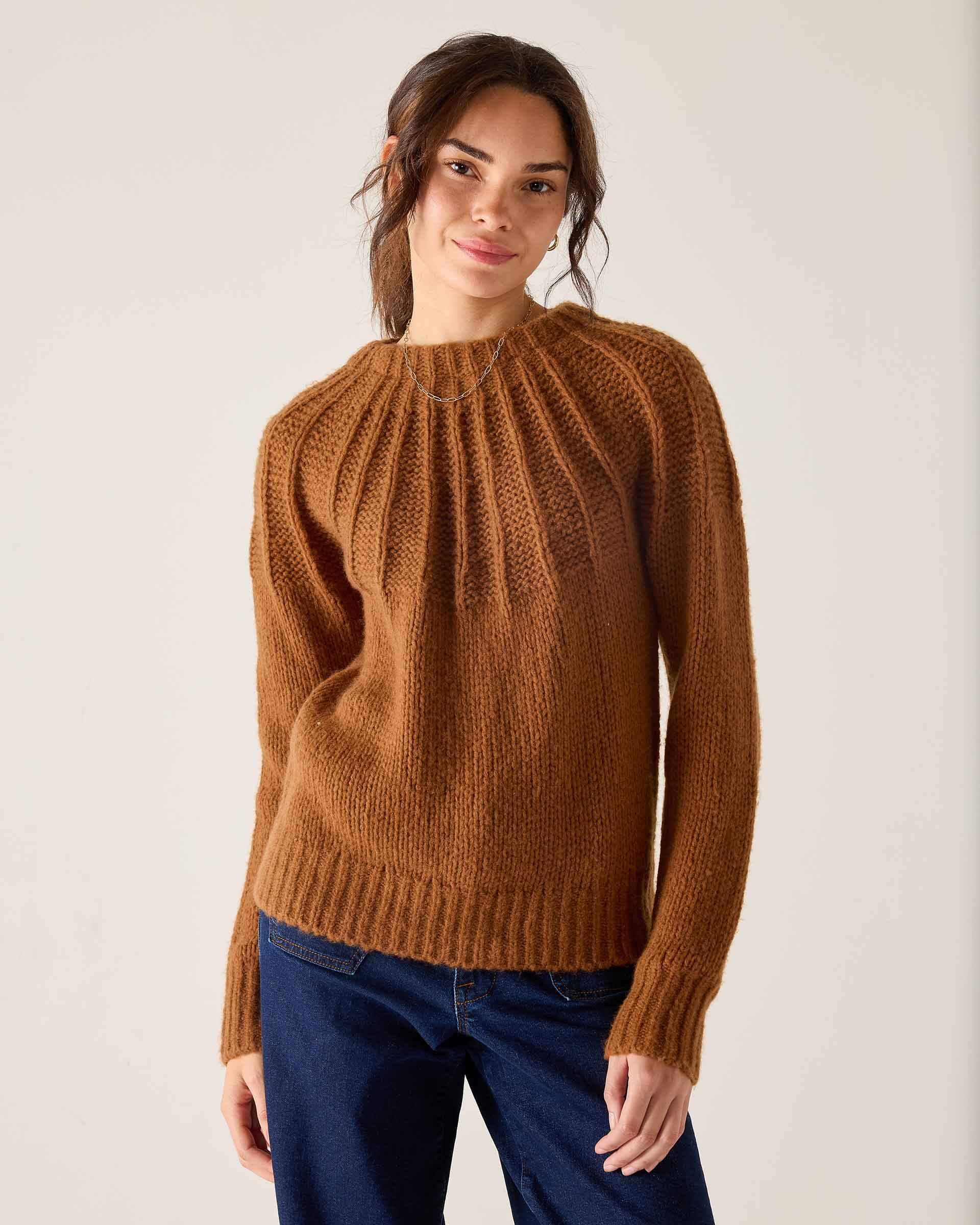 Ladies' travel-ready cinder orange knit sweater featuring a ribbed texture and pleated design.
