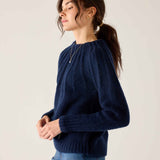 Navy ribbed knit sweater with a rounded neckline and long sleeves.