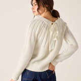 White knit sweater with ribbon detail and pointelle stitch.