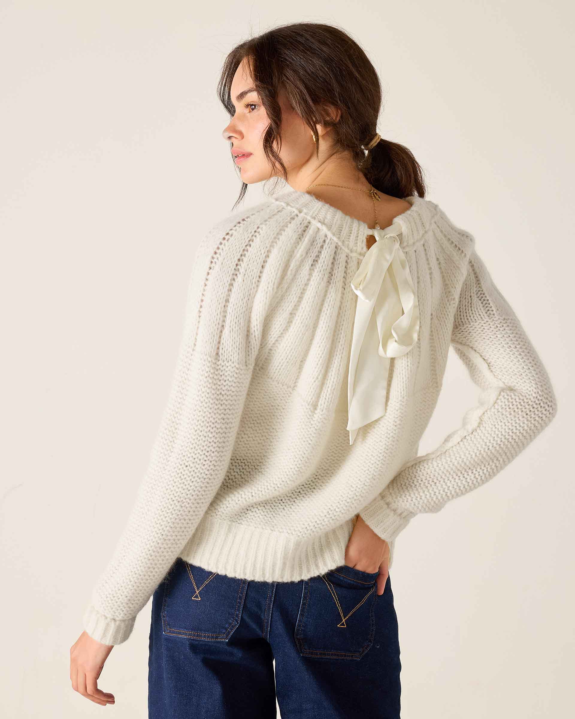 White knit sweater with ribbon detail and pointelle stitch.
