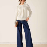 White knit ribbon sweater with ribbed texture and gathered detail.