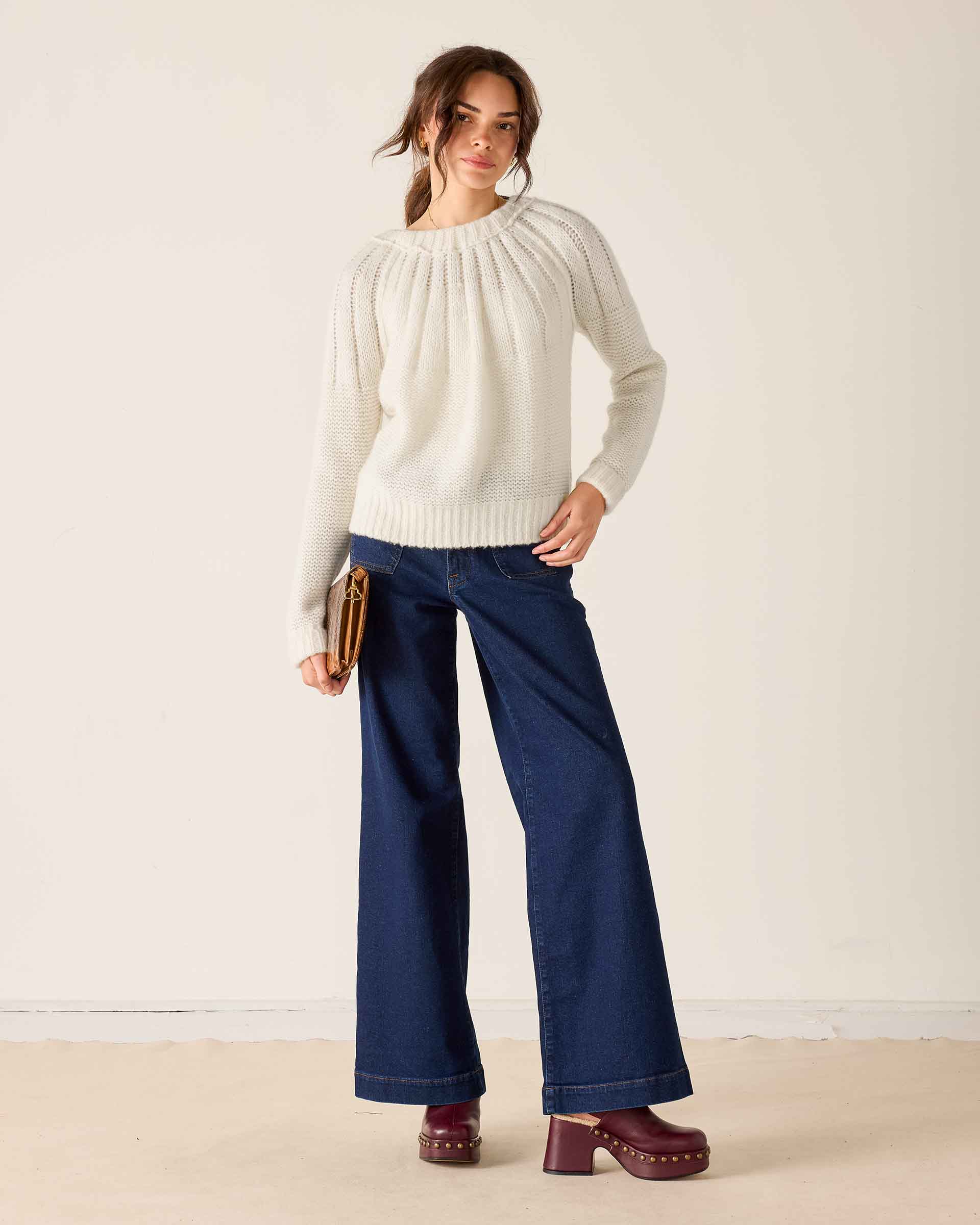 White knit ribbon sweater with ribbed texture and gathered detail.