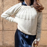 Women's travel-friendly cream ribbed knit sweater with a gathered neckline and textured detail.