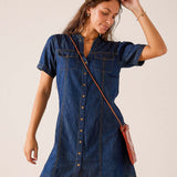 Dark blue denim button-down shirt dress with short sleeves and chest pockets.