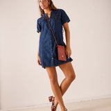 Dark wash blue denim short shirt dress with button front and pocket details