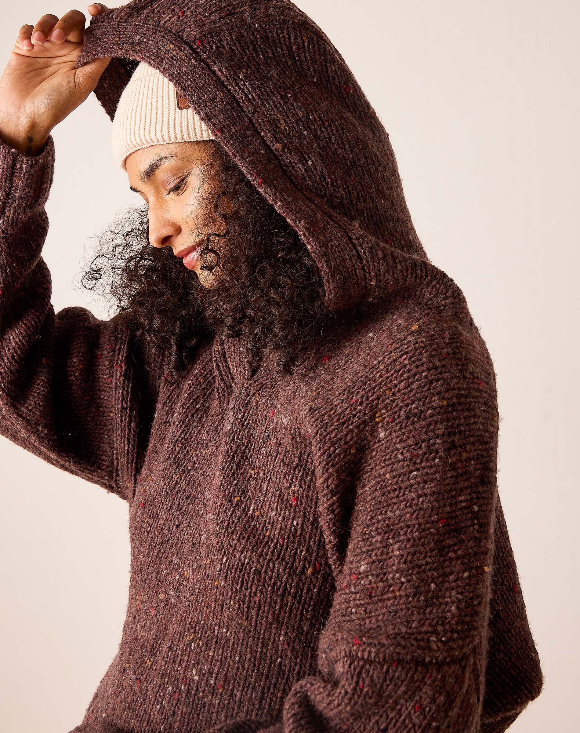 Chocolate brown hooded knit sweater with a cozy oversized fit and marled yarn detail.