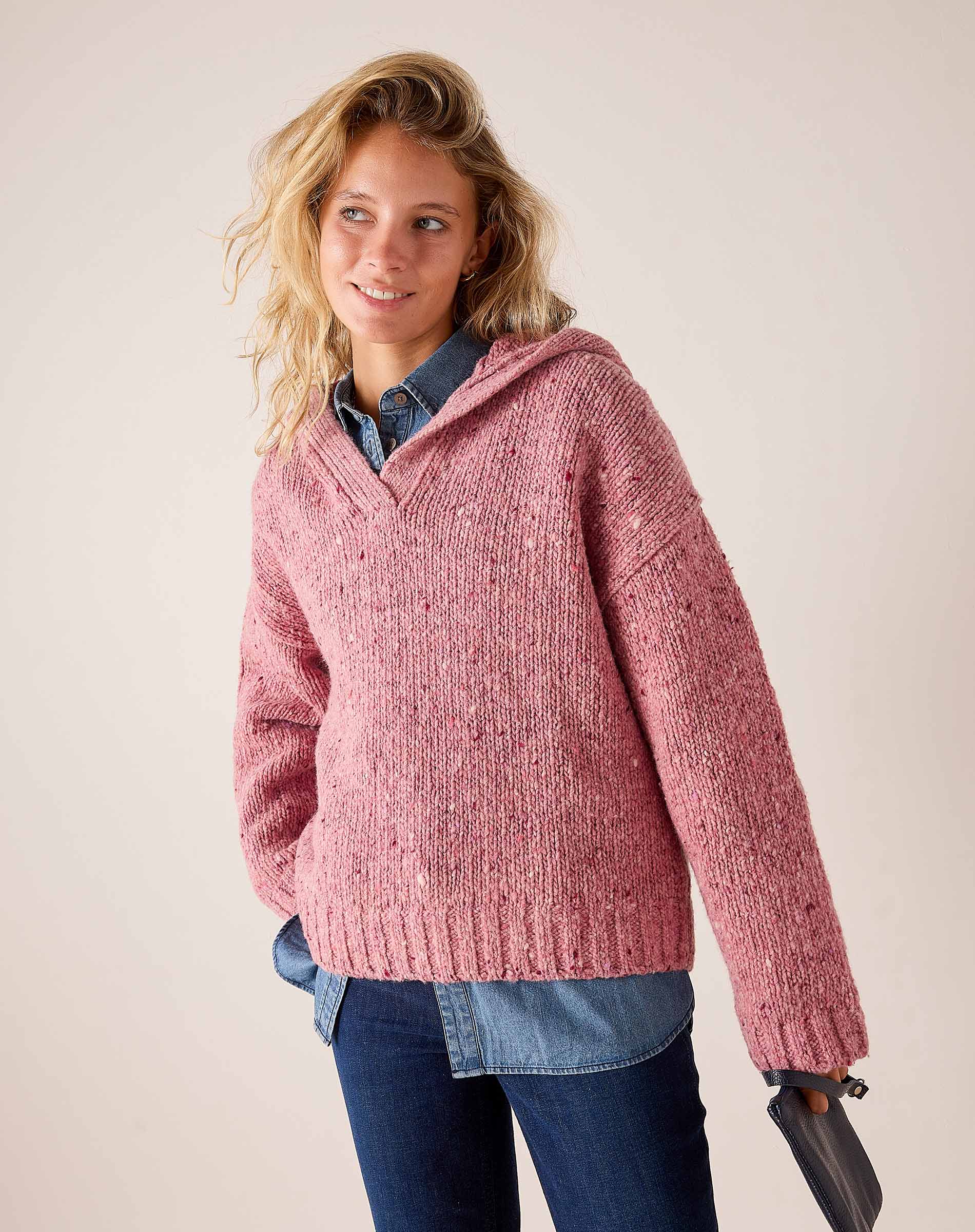 Women's travel-friendly rose pink knit hooded sweater with a relaxed fit and ribbed trim.
