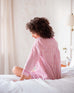 rear view of woman wearing over the cotton moon nightshirt sitting on bed