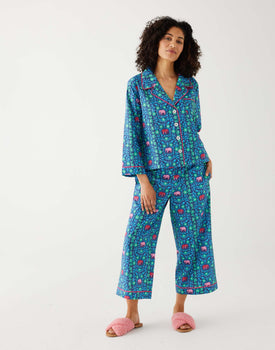 woman wearing matching pajama set with elephant garden print 