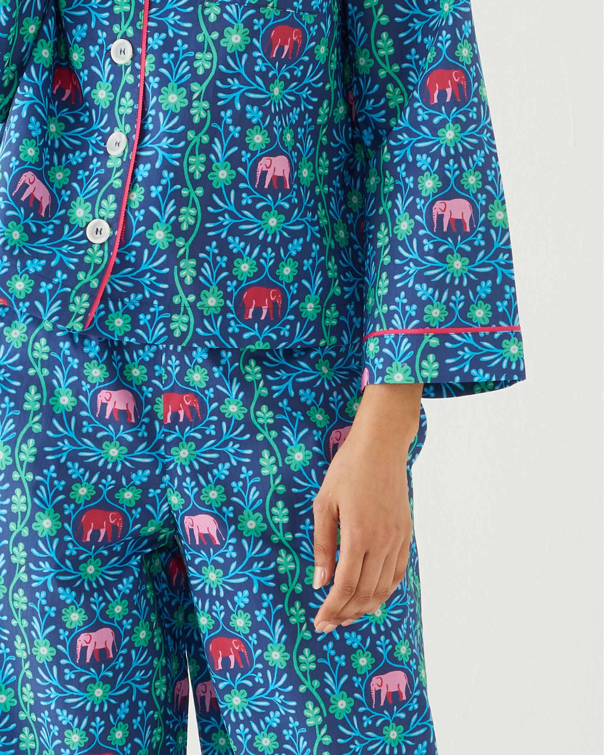 closeup of woman wearing mersea matching pajama set with elephant garden print