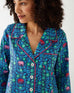 closeup of woman wearing mersea matching pajama set with elephant garden print
