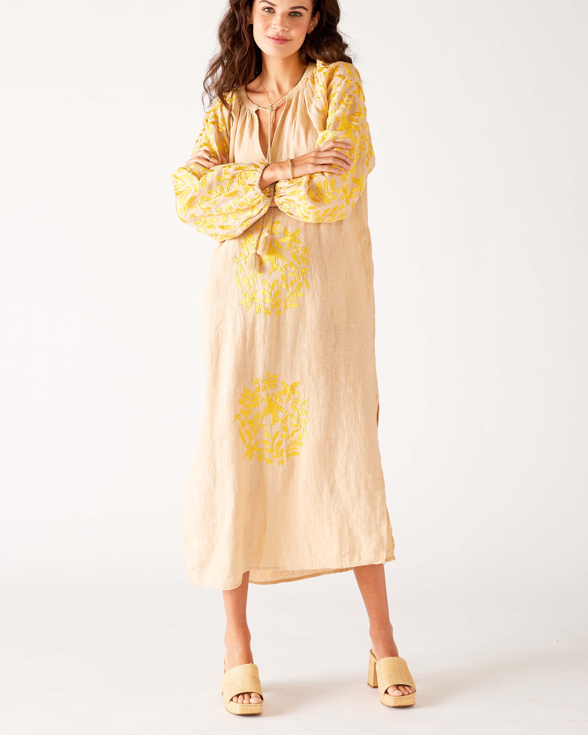 woman wearing tan and yellow maxi dress with embroidery