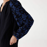 closeup of sleeve blue embroidery on black Mersea V-neck Palermo dress