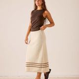 Ecru and almond crochet maxi skirt featuring a horizontal striped hem detail.