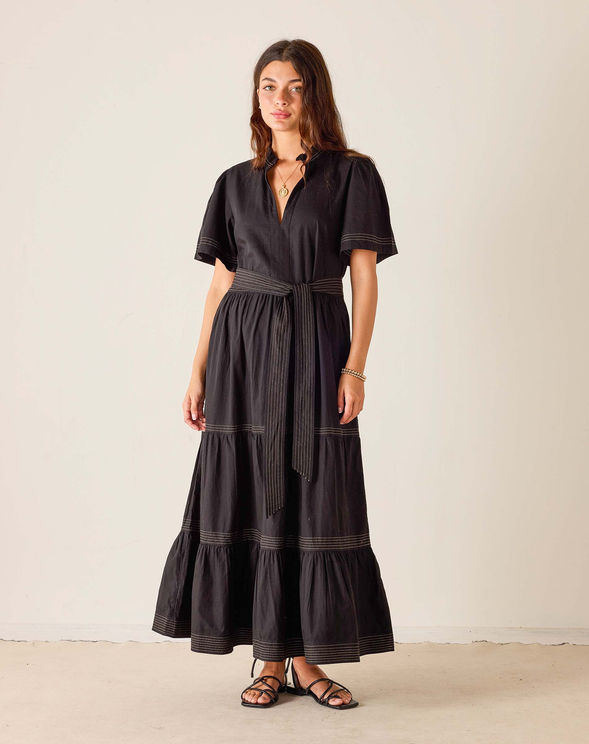 Woman wearing a black dress with a white background
