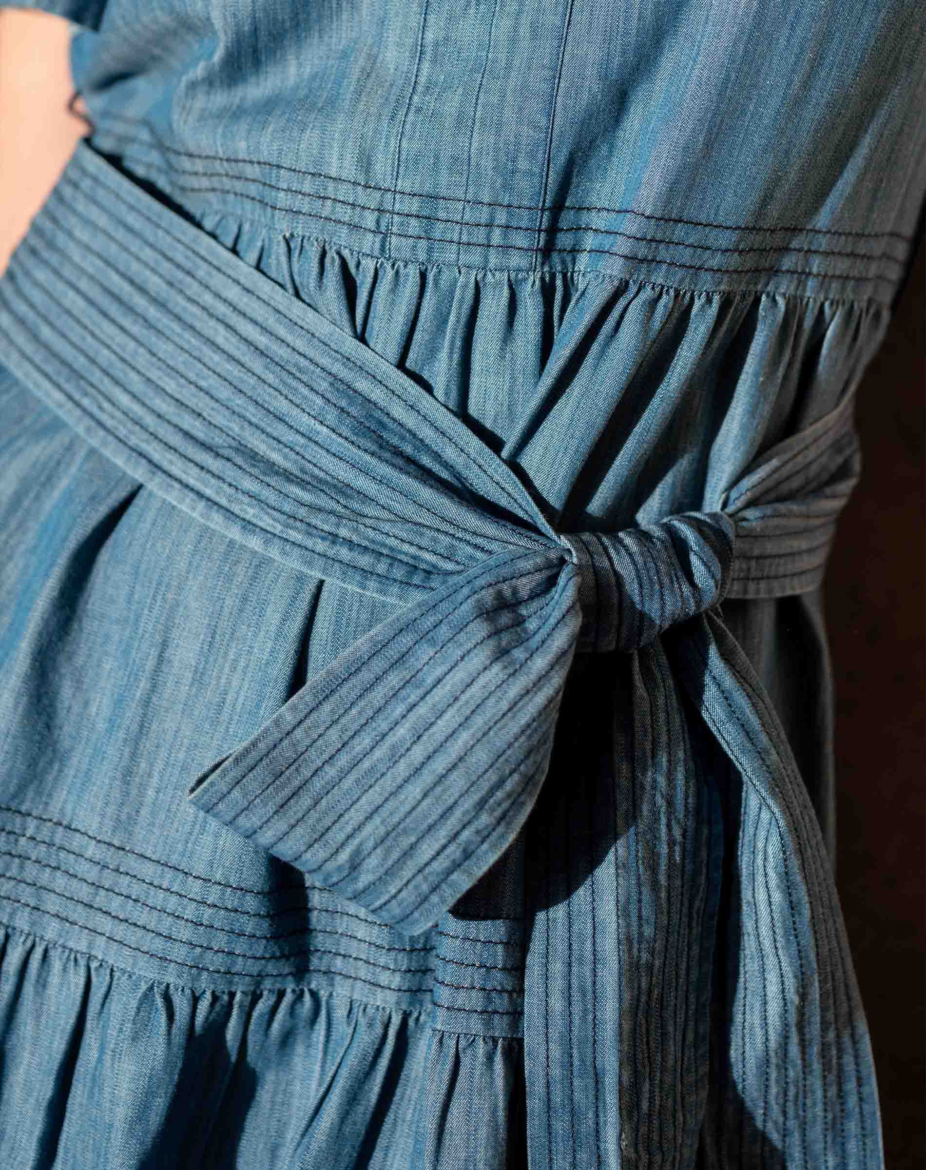 Close-up of a blue dress with a tie waist
