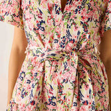 Floral dress with a tie waist on a plain background