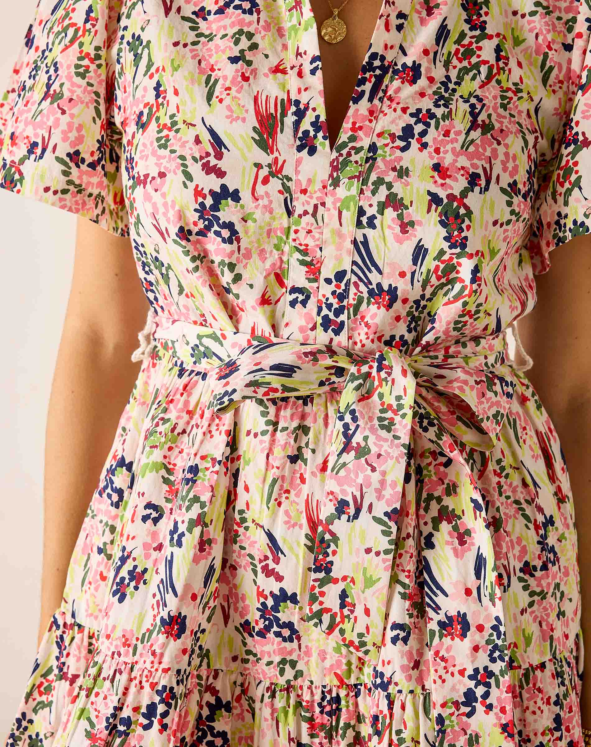 Floral dress with a tie waist on a plain background