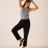 Black cashmere tapered pant with an elastic drawstring waist and a matching grey ribbed tank top.