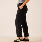 Black tapered cashmere pant with a relaxed fit and drawstring waist.