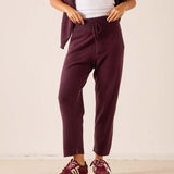 Plum cashmere tapered pant with an elastic waistband and drawstring detail.