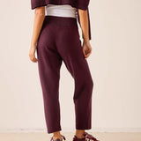 Plum cashmere tapered pants with a knit finish and a comfortable fit.