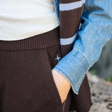 Truffle brown ribbed knit tapered pants featuring a wide waistband and comfortable side pockets.