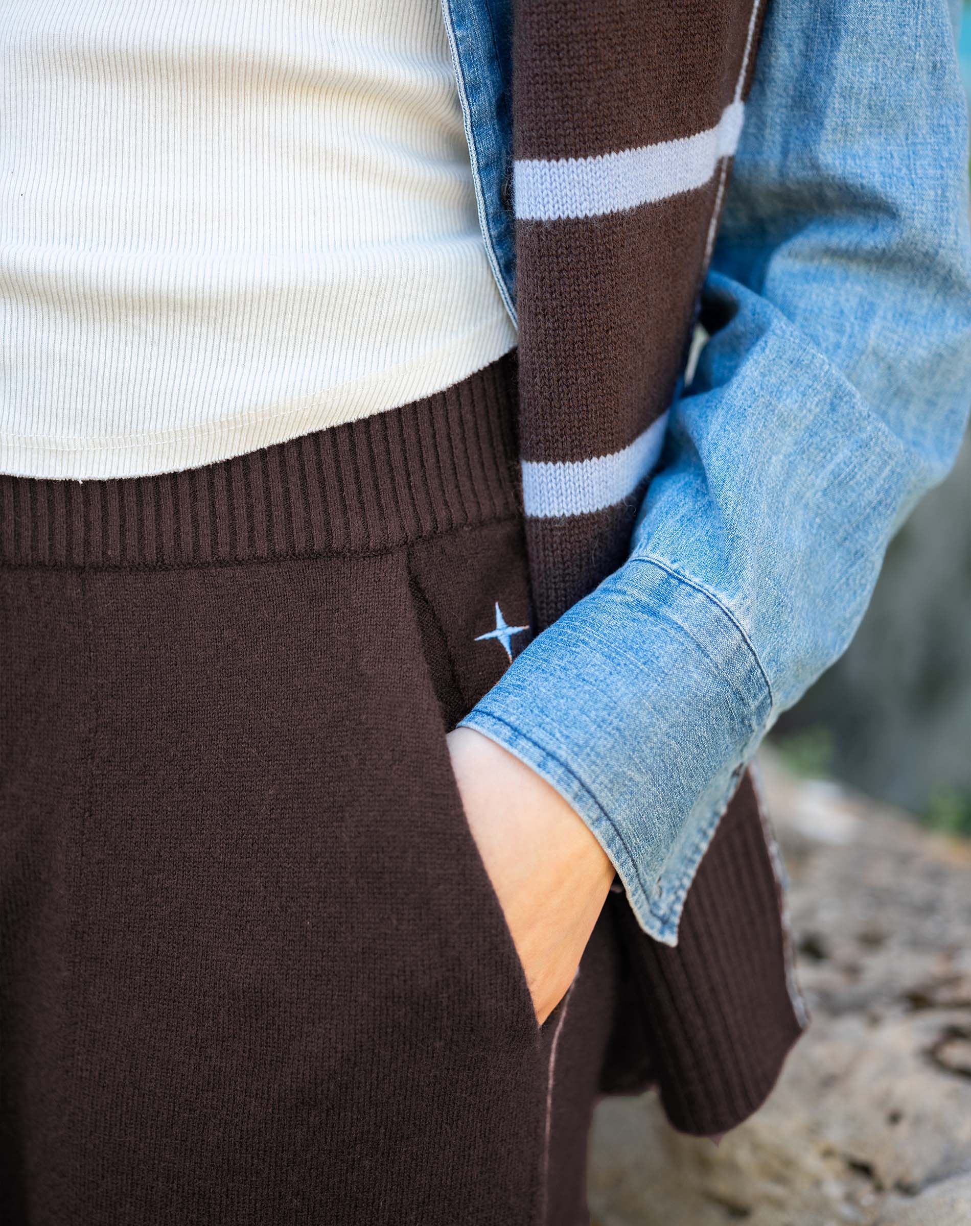 Truffle brown ribbed knit tapered pants featuring a wide waistband and comfortable side pockets.