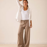 Women's travel-friendly beige wide-leg cashmere trousers with a drawstring waist.