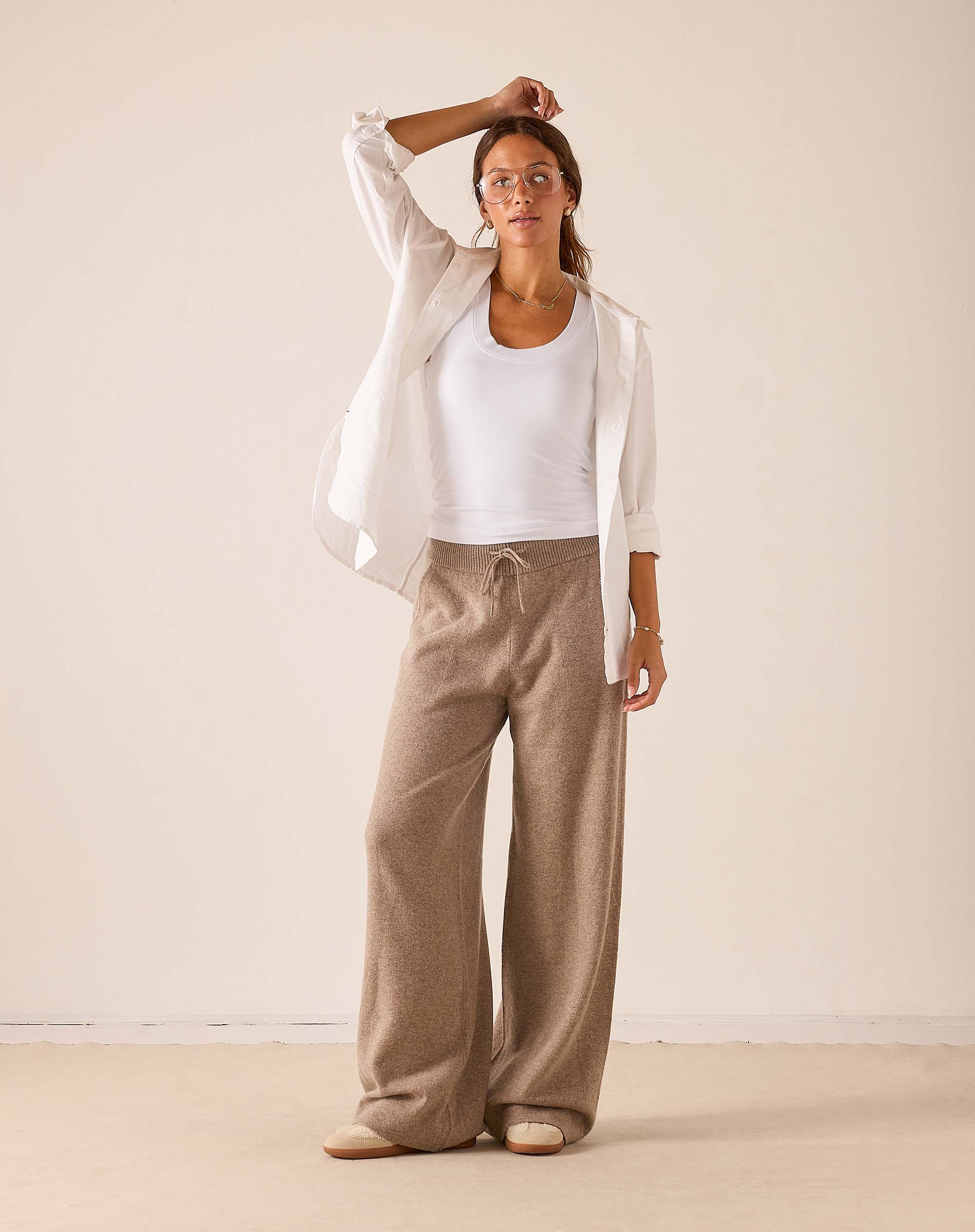 Women's travel-friendly beige wide-leg cashmere trousers with a drawstring waist.