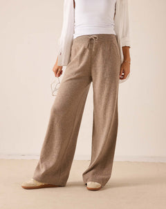 Beige wide-leg cashmere knit trousers with a drawstring waist.