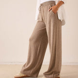 Beige wide-leg cashmere pants with a ribbed waistband and soft knit finish.